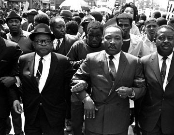 The Rev. Ralph Abernathy, right, and Bishop Julian Smith, left, flank Dr. Martin Luther King, Jr., during a civil rights march