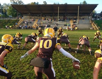 The Titusville High School football team warms up before the homecoming game (Kevin McCorry/Keystone Crossroads)