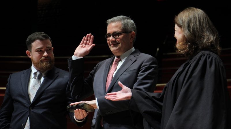 Philadelphia District Attorney Larry Krasner sworn in by his wife, Judge Lisa Millett Rau with son Nathan holding Bible.