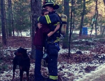 Tabernacle Fire Lt. Jason Penwell hugs his 15-year-old son after responding to a blaze that gutted his family's home Wednesday. (Maryann Smith)
