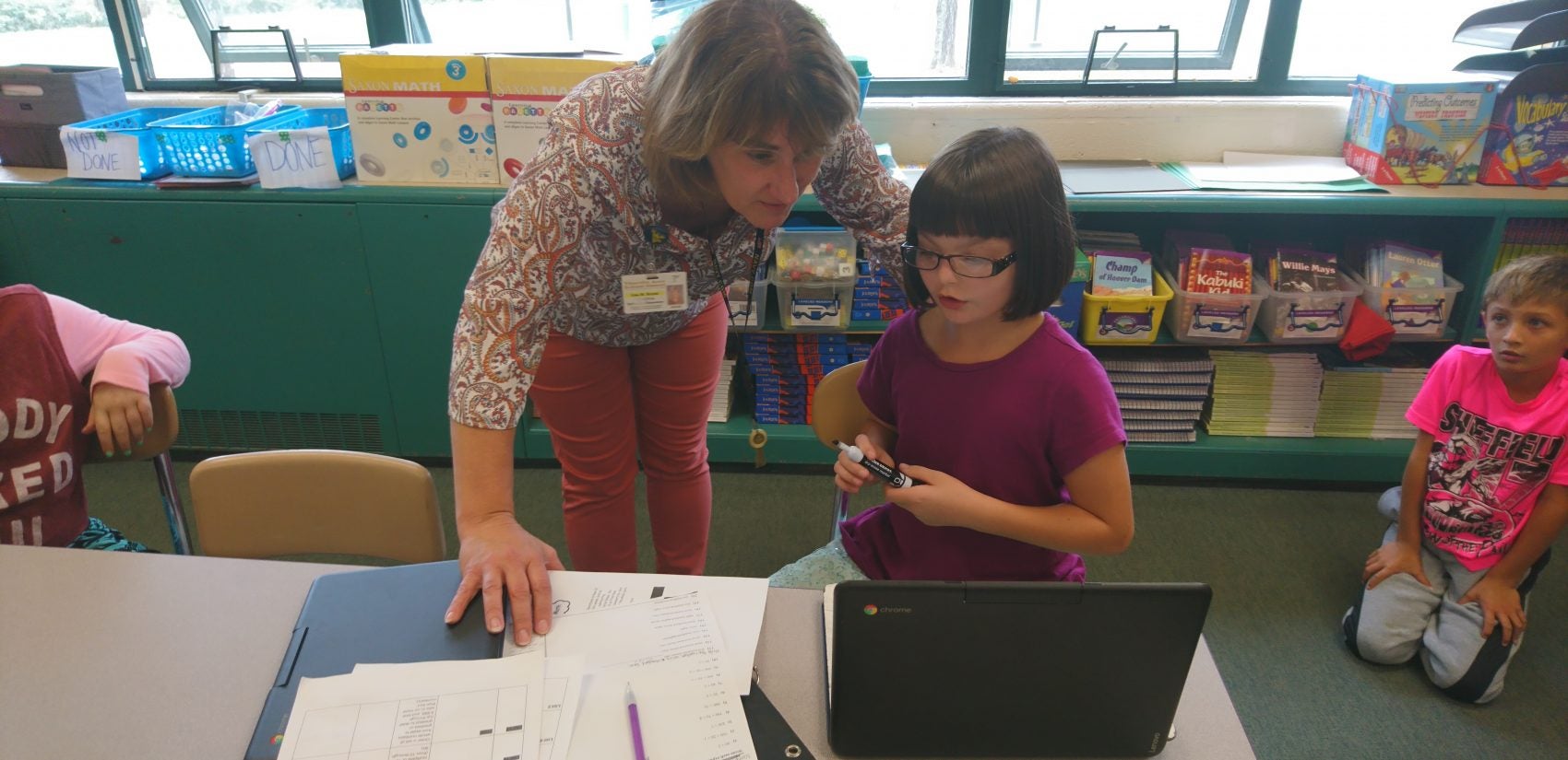 Principal Lisa Royek works with a student at Titusville's Hydetown Elementary (Kevin McCorry/Keystone Crossroads)