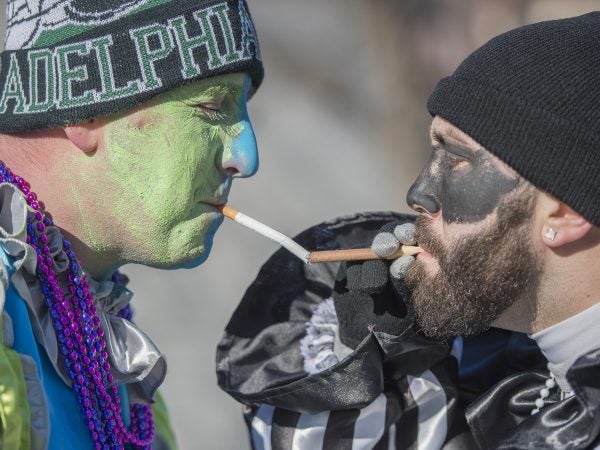 Mike Lyons right lights Rick Aith's cigarette. The men are members of the Pirates and Froggy Carr.