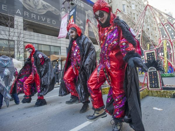 Golden Sunrise members Aubrey Bryan, left, Sean Bryan, and Coral Pistilli, right dance along South Broad St.