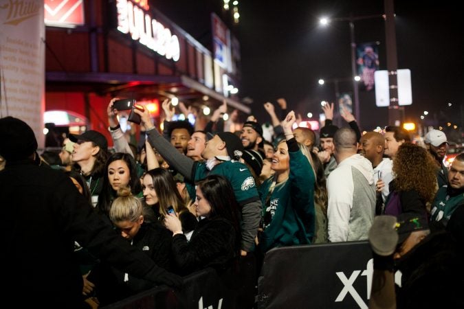 Eagles fans cheer outside of Xfinity Live after an Eagles touchdown in the NFC Championship Game against the Minnesota Viking Sunday Night. (Brad Larrison for WHYY)