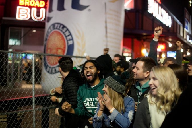 Eagles fans cheer outside of Xfinity Live after an Eagles touchdown in the NFC Championship Game against the Minnesota Viking Sunday Night. (Brad Larrison for WHYY)