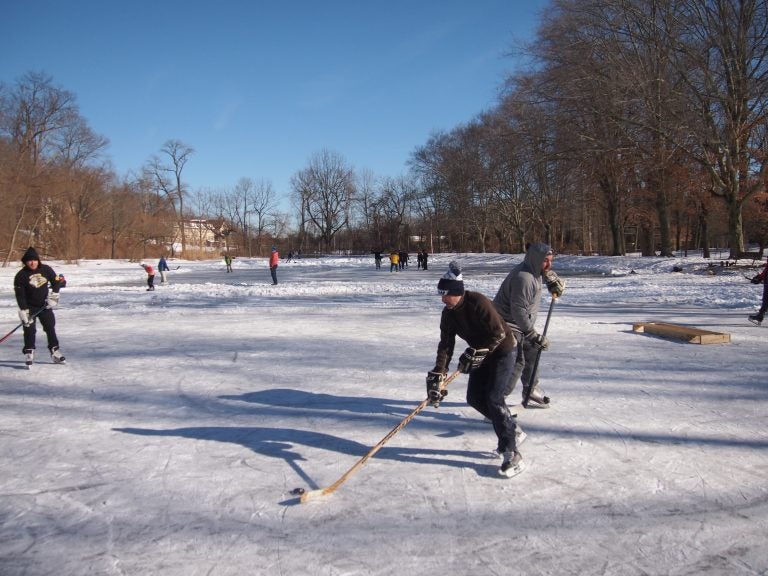 Ice skaters take advantage of a rare frozen pond to play some hockey  at Fenimore Woods in Radnor Township, Delaware County. (Shai Ben-Yaacov/WHYY)
