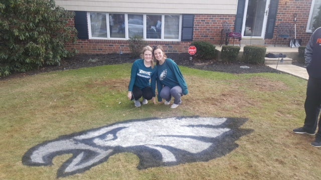 Lauren Bruton and Erin Lynch helped stencil 10 lawns with the Eagles logo