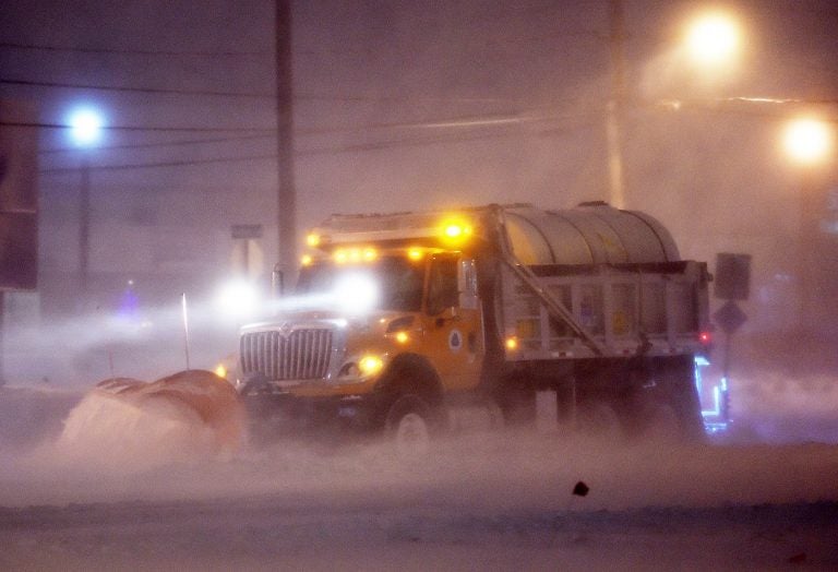 A DelDOT snow plow clears the roads near Rehoboth Beach on Thursday. (Chuck Snyder/for WHYY)