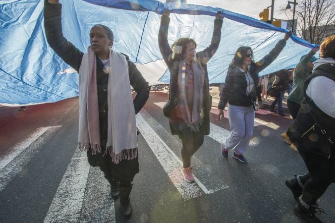 Supporters of Puerto Rico carry the Puerto Rican flaq during the march. (Jonathan Wilson for WHYY)
