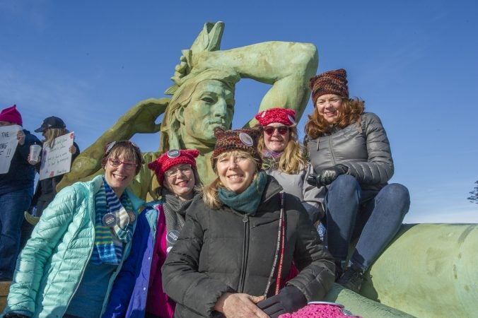 Friends and Penn State alumni pose for a photo at the Logan Circle Fountain. (Jonathan Wilson for WHYY)