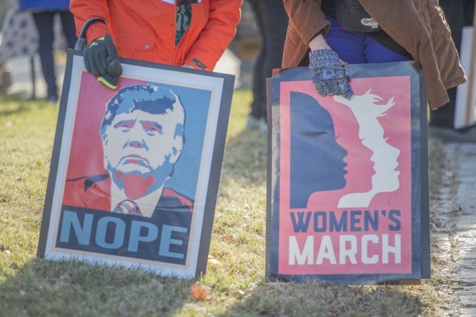 2 of the many protest signs at the march. (Jonathan Wilson for WHYY)