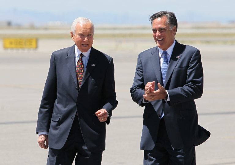 In this June 8, 2012 file photo, Mitt Romney, right, laughs walking side-by-side with Sen. Orrin Hatch, R-Utah, who met him on the tarmac at Salt Lake International Airport.