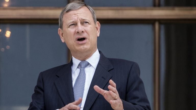 Chief Justice John Roberts stands outside the Supreme Court in Washington, D.C., in June, following new Associate Supreme Court Justice Neil Gorsuch investiture ceremony, a ceremony to mark his ascension to the bench.