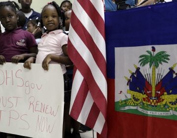 Children hold signs at a November news conference in Miami in support of renewing temporary protected status for immigrants from Central America and Haiti. (Lynne Sladky/AP)