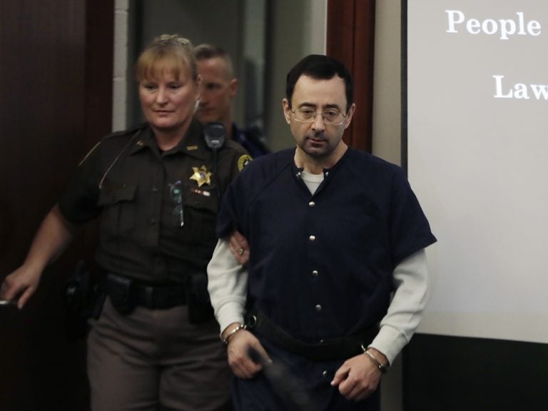 Larry Nassar is escorted into court in Lansing, Mich., on Wednesday, where he was sentenced to 40 to 175 years in prison. (Carlos Osorio/AP)