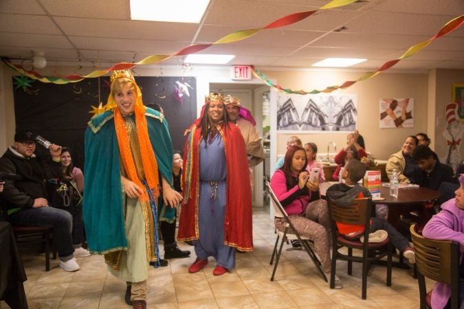 Tom Diagostino, (left), Tashonn Bungy, and Robertoluis Lugo dress up as the three kings to pass out gifts to the children at the celebration. APM threw a Three Kings Day/Octavious celebration for diplaced families from Puerto Rico in North Philadelphia on January 12 2018. (Emily Cohen for WHYY)