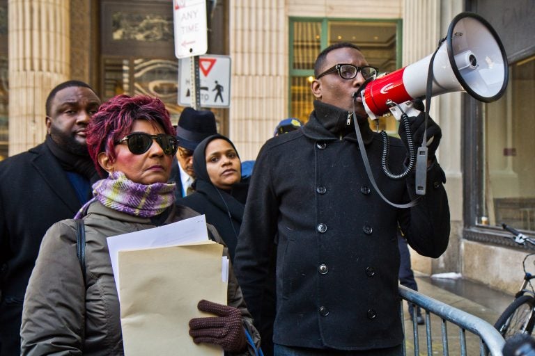 Christine Riddick, mother of Eric Riddick, (left) his wife Dana Baker-Riddick, (center) and Black Lives Matter activist Asa Khalif protest outside the Philadelphia district attorney’s office in an attempt to deliver information they say will prove the innocence of Eric Riddick, who’s been incarcerated for 26 years. (Kimberly Paynter/WHYY)