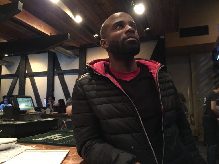 Atlanta Falcons fan Pierre Saint-Amour watches his team take on the Philadelphia Eagles at City Tap Room. (Avi Wolfman-Arent/WHYY)