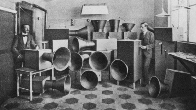 The futurist artist Luigi Russolo (left)  with his noise machine, invented for futurist 