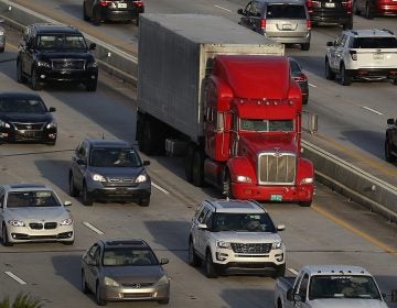 A tractor-trailer rolls along the highway in Miami last November. The trucking industry needs to hire almost 900,000 more drivers in order to meet rising demand, according to an industry analysis. (Joe Raedle/Getty Images)