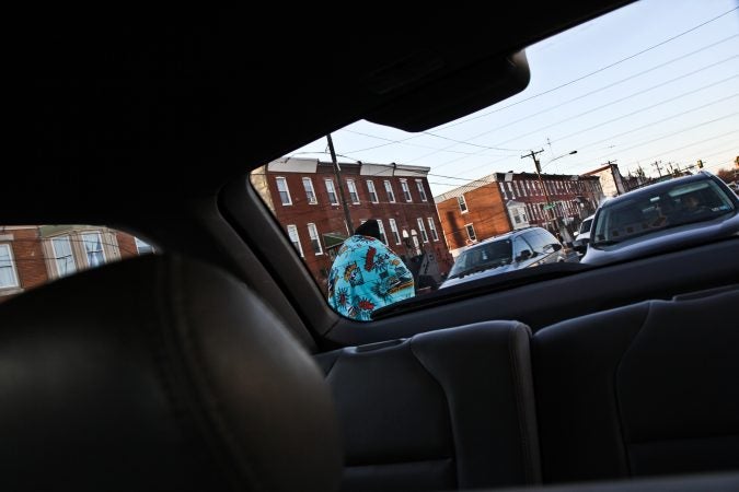 Homeless Outreach workers tell a panhandler on Lehigh Avenue that they will be back with a coat for him.