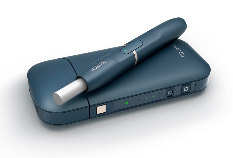 Philip Morris' iQOS device heats tobacco but stops short of burning it, an approach the company says reduces exposure to tar and other toxic byproducts of burning cigarettes. (Philip Morris via AP)