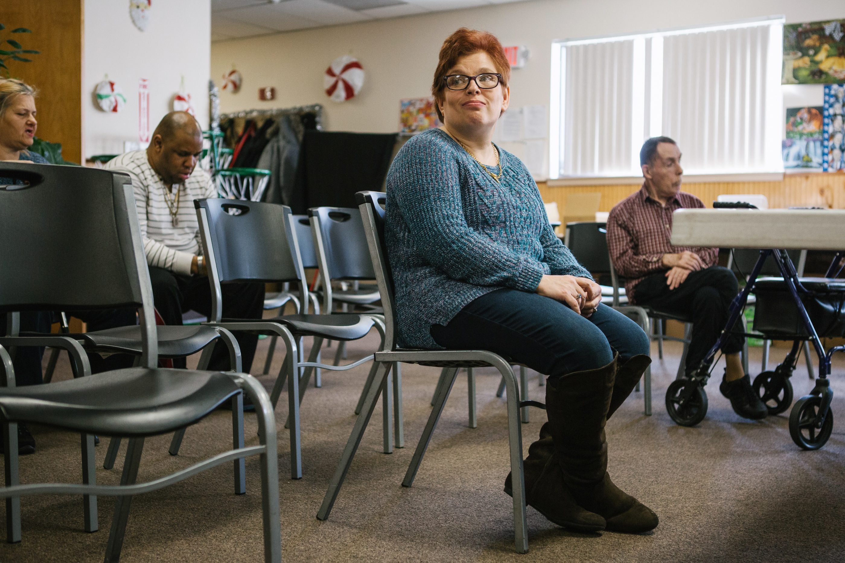 Pauline sits after practice for a Christmas show with fellow group members of a day program at the Arc Northeastern Pennsylvania. Pauline, who has intellectual disabilities, has been with the Arc program since 2014, after an emergency removal from her previous caretaker's home by Adult Protective Services when she was sexually assaulted.