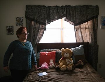 Pauline stands in her room after coming home from a day program for adults with intellectual disabilities.