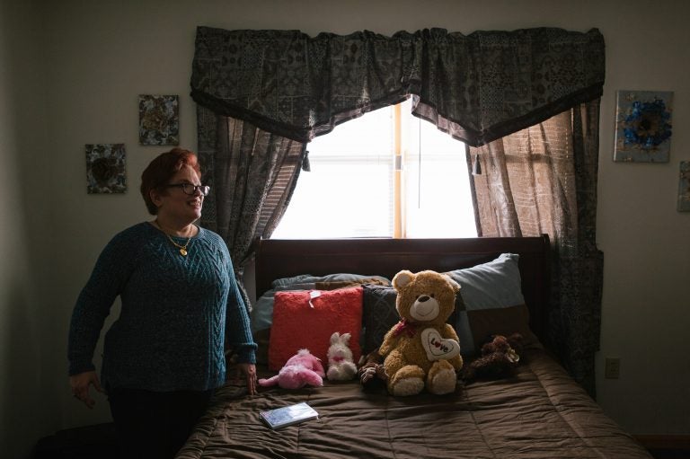 Pauline stands in her room after coming home from a day program for adults with intellectual disabilities.