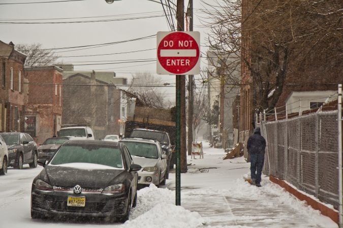 A Kensington resident works to keep the sidewalk clear. (Kimberly Paynter/WHYY)