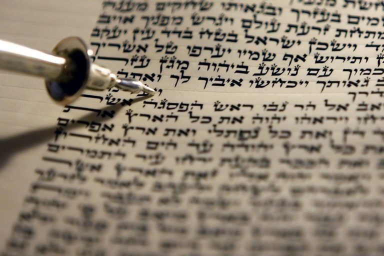 A silver place marker is seen on a Torah at a Jewish temple in Philadelphia. (AP Photo/ Joseph Kaczmarek, file)