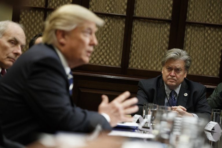 White House Chief Strategist Steve Bannon listens at right as President Donald Trump speaks during a meeting