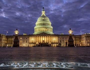Lights shine inside the U.S. Capitol as night falls in Washington.