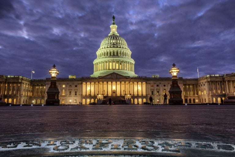 Lights shine inside the U.S. Capitol as night falls in Washington.