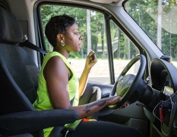 Kristal Bush chews on sunflower seeds to keep alert on the long drive to Huntingdon, Pennsylvania. Bush is the founder of @BridgingTheGapLLC transportation company. Several times a week, her vans pick up riders from their homes throughout Philadelphia and drive them to see loved ones in prisons across the state.