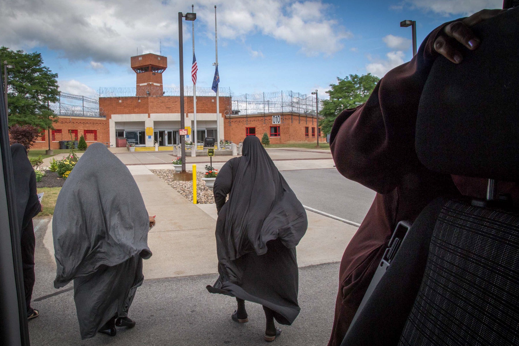 Aisha, Tysheen and Tanesha run toward the doors of Smithfield prison, not wanting to waste a moment of their visiting day. The vans drop off between 9 a.m. and 10 a.m., and return when the visits let out between 3 p.m. and 3:30 p.m. 