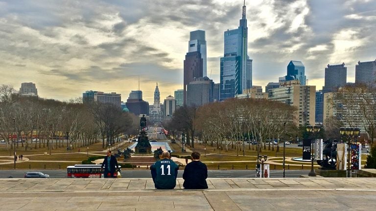 An Eagles fan takes in the city from the top of the steps to the Philadelphia Museum of Art, also known as the Rocky steps. (Emma Lee/WHYY)