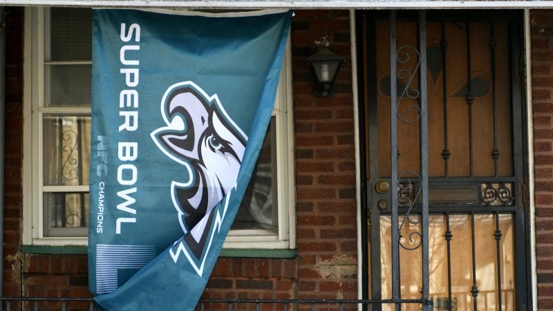 Flag in support of the Philadelphia Eagles hang on the front porch of a home in Roxborough, on Wednesday. (Bastiaan Slabbers for WHYY)