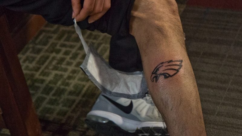 The first 50 people to show up at Moo Tattoo on South Street Wednesday got a free Eagles tattoo. The giveaway was sponsored by Momentary Ink, which also gave out an unlimited number of temporary tattoos. (Kimberly Paynter/WHYY)