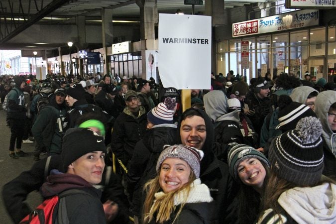 Regional rail users wait in lines that stretch for blocks after the Super Bowl parade. (Emma Lee/WHYY)