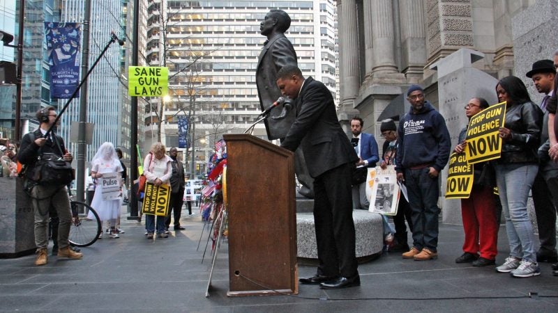 The Rev. Nicolas O'Rourke, of the Living Water United Church of Christ in Northeast Philadelphia, says a prayer for the victims of gun violence during a vigil for the Parkland, Florida, school shooting victims. (Emma Lee/WHYY)