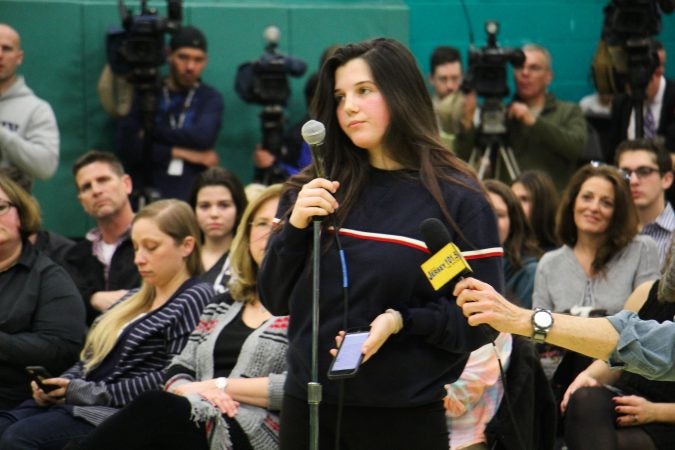 Cherry Hill East senior Julianna Martinez is the first to speak at a school board meeting where hundreds turned out to discuss school security and the rumored suspension of a teacher for his remarks to students about the Parkland school shooting. (Emma Lee/WHYY)