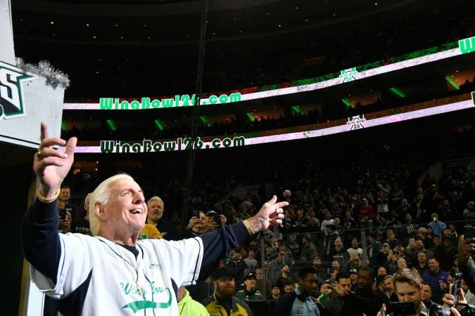 Former player and coach Frank Reich waves to fans as he makes a surprise appearance during Wing Bowl 26, at the Wells Fargo Center, on Friday. (Bastiaan Slabbers for WHYY)