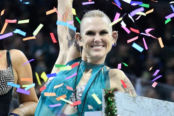 Competitive eater Molly Schuyler waves to fans as she enters the arena ahead of the Wing Bowl 26, at the Wells Fargo Center, on Friday.  (Bastiaan Slabbers for WHYY)