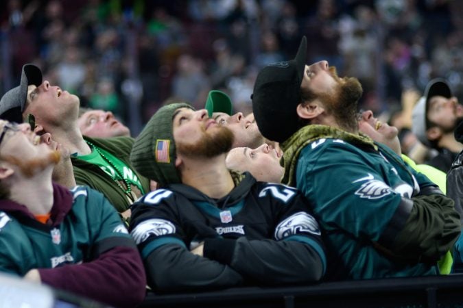 Fans look up at the big screen in the center fo the arena to follow what happens on stage during the Wing Bowl 26, at the Wells Fargo Center, on Friday.  (Bastiaan Slabbers for WHYY)