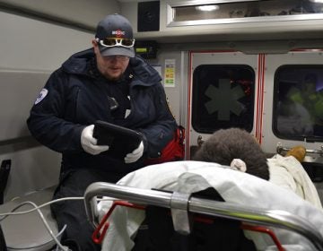 Susquehanna Township EMS Captain Dan Tempel collects information from a man who he just revived from a drug overdose. (Brett Sholtis/Transforming Health)