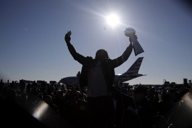 Philadelphia Eagles running back LeGarrette Blount holds up the Vince Lombardi Trophy while displaying it to fans gathered to welcome them in Philadelphia a day after defeating the New England Patriots in Super Bowl 52 in Minneapolis, Monday, Feb. 5, 2018. (AP Photo/Julio Cortez)