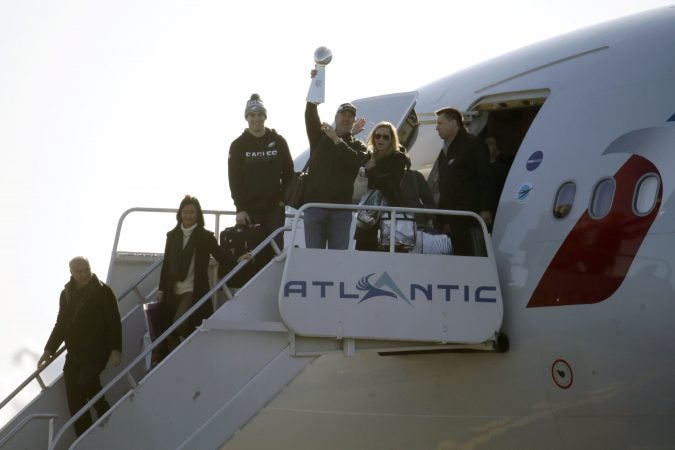 Eagles head coach Doug Pederson holds up the Vince Lombardi Trophy while displaying it to fans gathered to welcome them in Philadelphia a day after defeating the New England Patriots in Super Bowl 52 in Minneapolis, Monday, Feb. 5, 2018. (AP Photo/Julio Cortez)