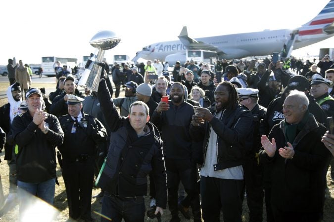 Philadelphia Eagles general manager Howie Roseman holds up the Vince Lombardi Trophy while displaying it to fans gathered to welcome them in Philadelphia a day after defeating the New England Patriots in Super Bowl 52 in Minneapolis, Monday, Feb. 5, 2018. (AP Photo/Julio Cortez)