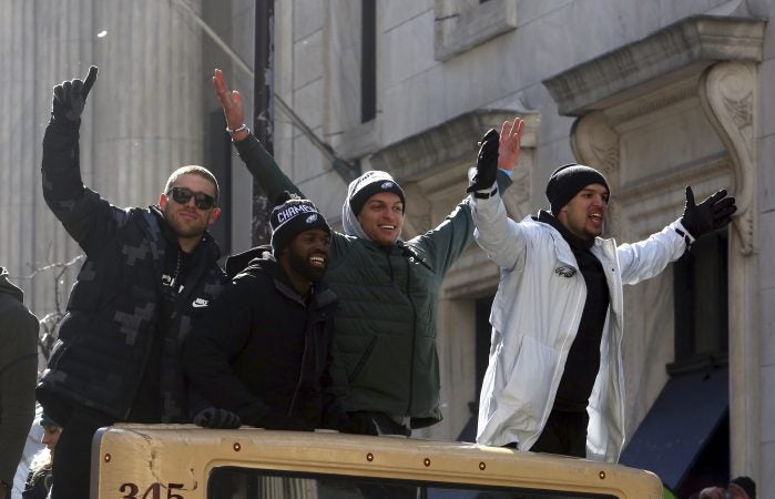 Philadelphia Eagles NFL football team wide receivers Zach Ertz, left, and Mack Hollins, second from right, ride with teammates in the Eagles team parade and celebration Thursday Feb. 8, 2018, in Philadelphia. The Eagles defeated The New England Patriots in Super Bowl 52. (AP Photo/Jacqueline Larma)